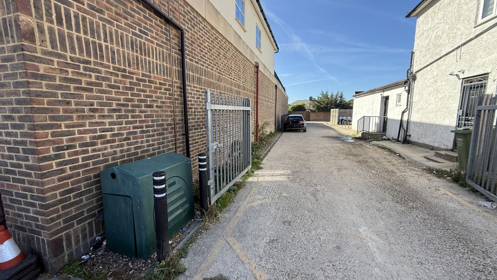 Lot: 150 - FREEHOLD PARCEL OF LAND INCLUDING PART OF THE ADJOINING ROADWAY - External view from front of site